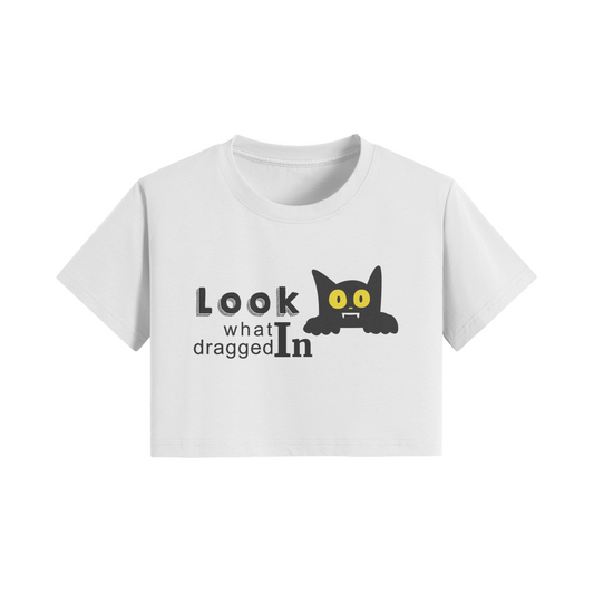 White crop t-shirt with "Look What Dragged In" vampire cat graphic design.